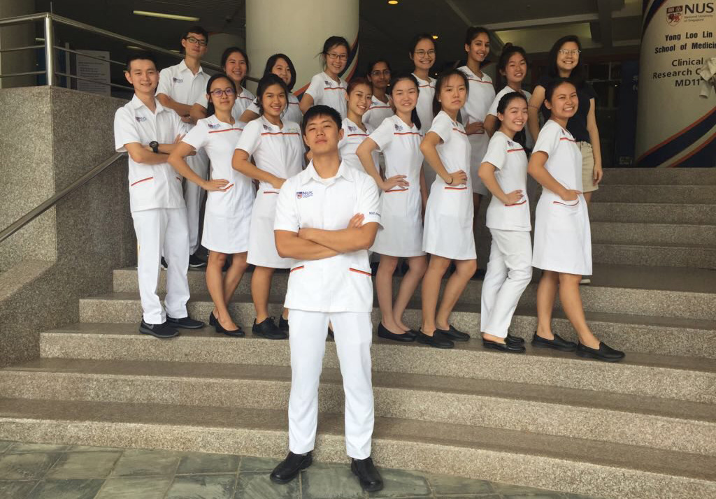 Zheng An and his classmates posing on the steps of NUS Nursing.